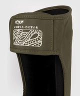 Protège-tibias Venum Serpenti – Kaki/Bronze, VENUM-05757-590